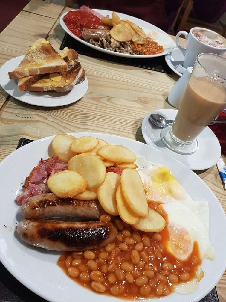 Breakfast plate with bacon, eggs and potato cakes served alongside a latte at Chalfonts Café in Hingham.