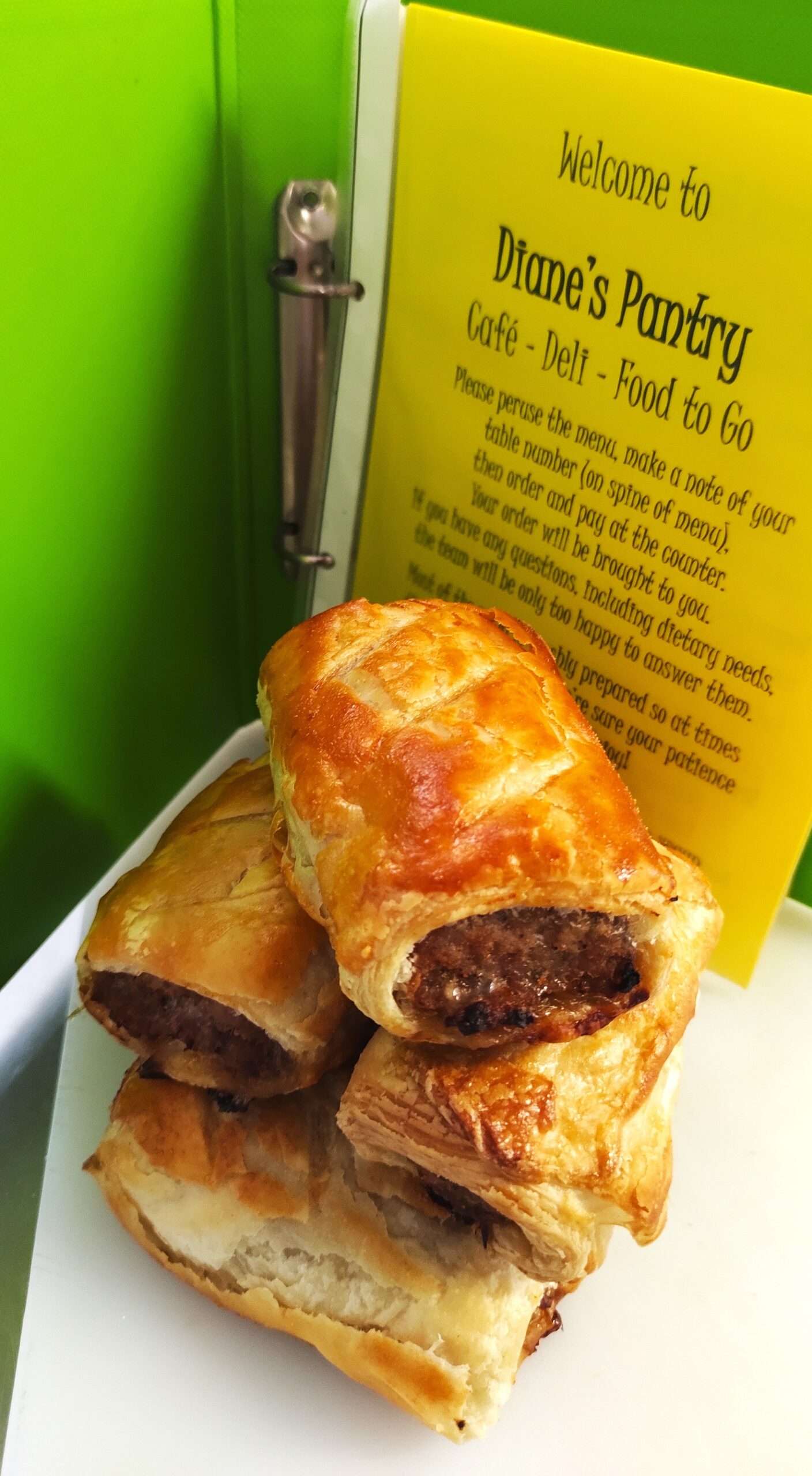 Freshly baked golden sausage roll displayed on a counter at Diane’s Pantry in Reepham.