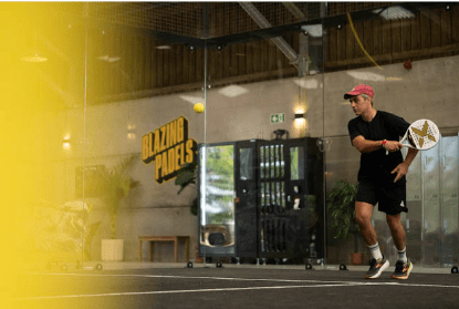Indoor padel court at Blazing Paddles Norfolk, with players using the modern covered sports facility at Salle Moor Farm.