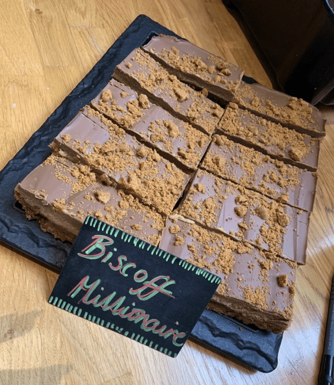 Homemade chocolate biscuit traybake cut into slices and displayed at A Piece of Cake café in Coltishall.