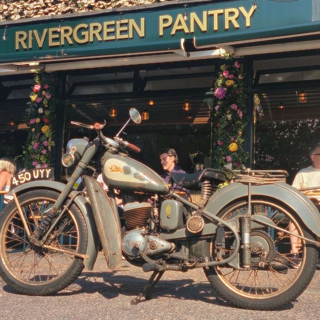 Exterior of River Green Pantry with motorbike, outdoor displays and colourful frontage in Norfolk.