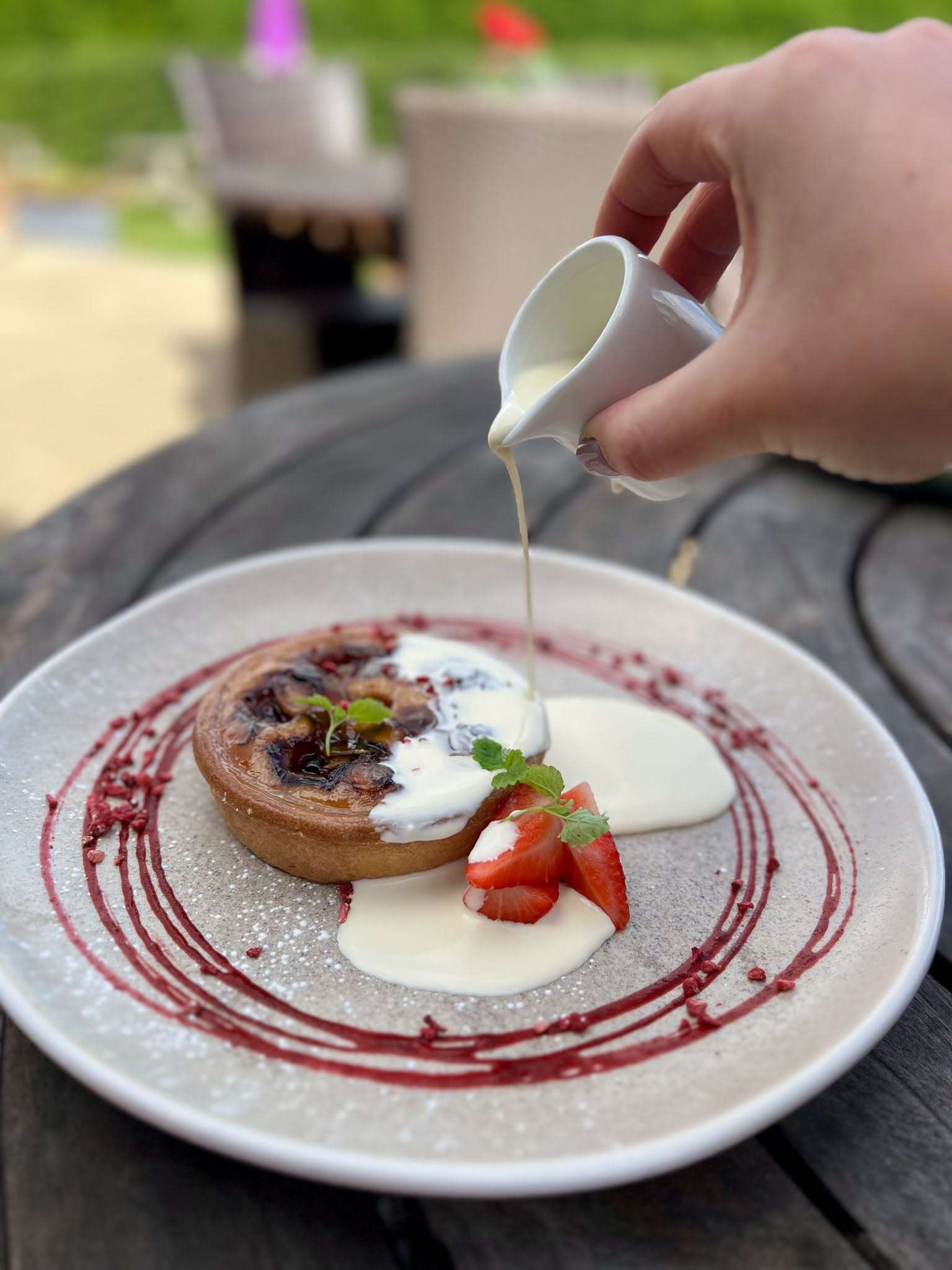 Dessert being finished with cream at the Parson Woodforde dining restaurant.